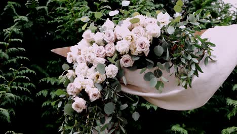 elegant floral wedding arrangement with soft pink roses and greenery