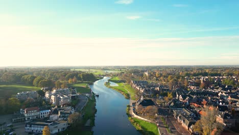 aerial view of a dutch town along a river in autumn