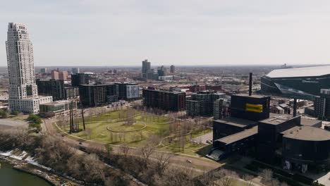 springtime drone push-in of gold medal park: lush green oasis in bustling minneapolis downtown with mississippi river and iconic landmarks