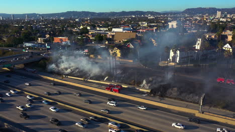 drone shot around nature burning near i-10 in arlington heights, los angeles