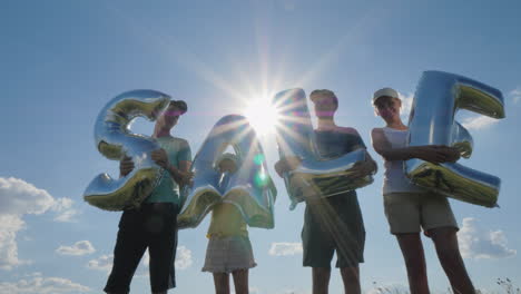 several people hold balloons with the word sale 4k video