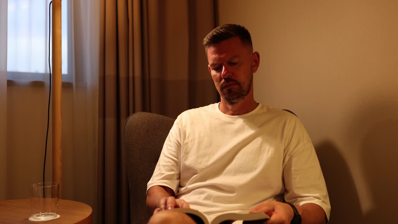 Man Reading a Book in an Armchair