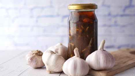 homemade garlic pickle in a glass jar on table ,