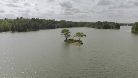 drone shot flying around a small island on a sunny summer day