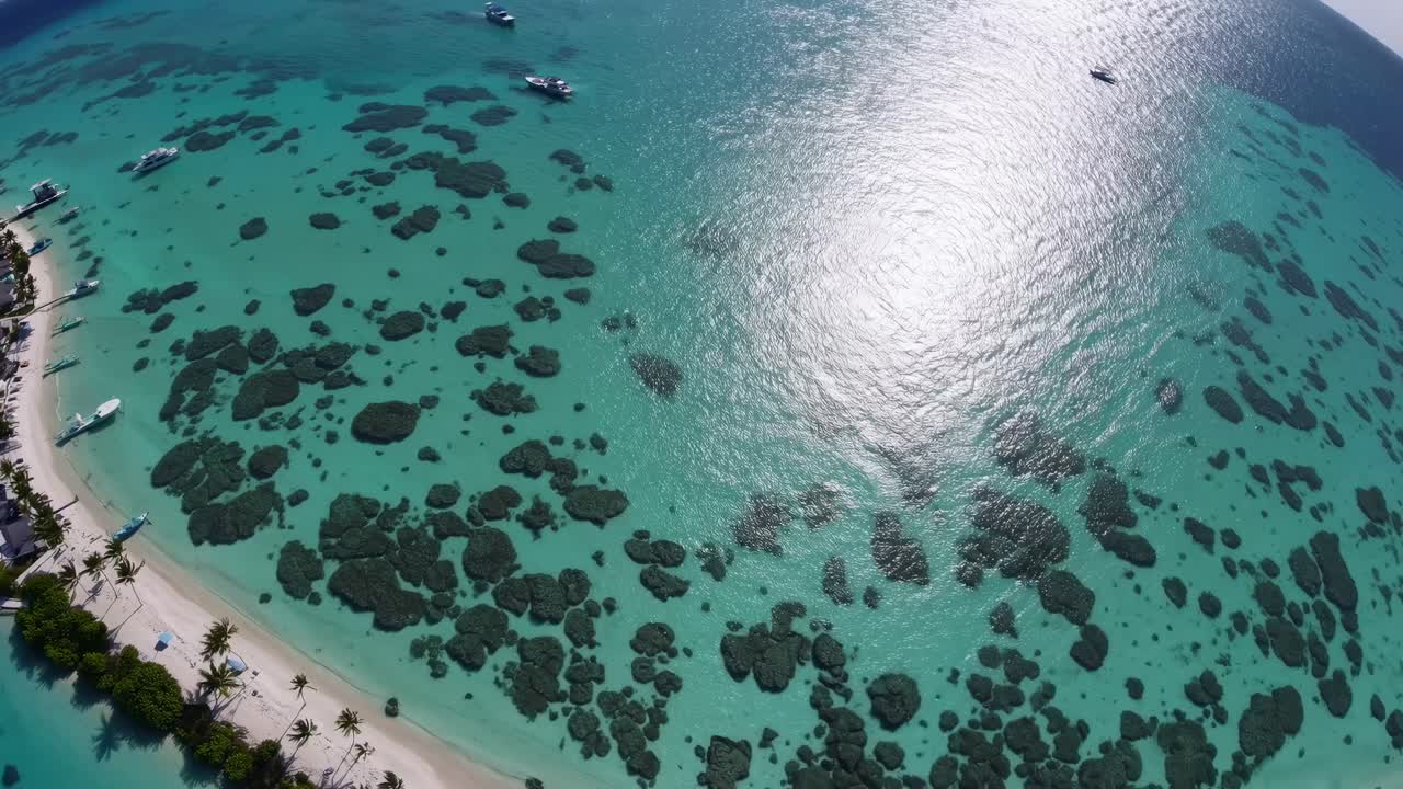 Aerial video shot of a tropical beach with turquoise waters and coral formations