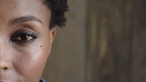 close up half face of african american woman eye looking at camera pensive contemplative beautiful detail