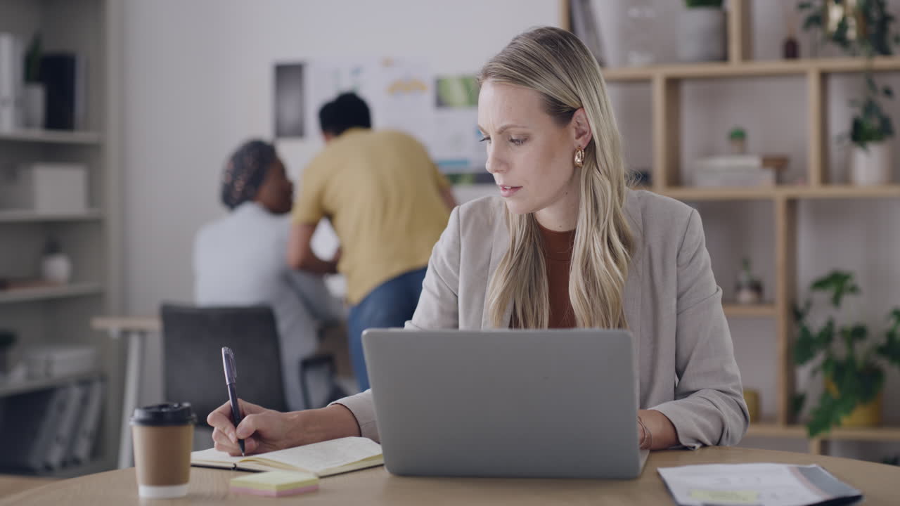 Woman working on laptop in an office setting
