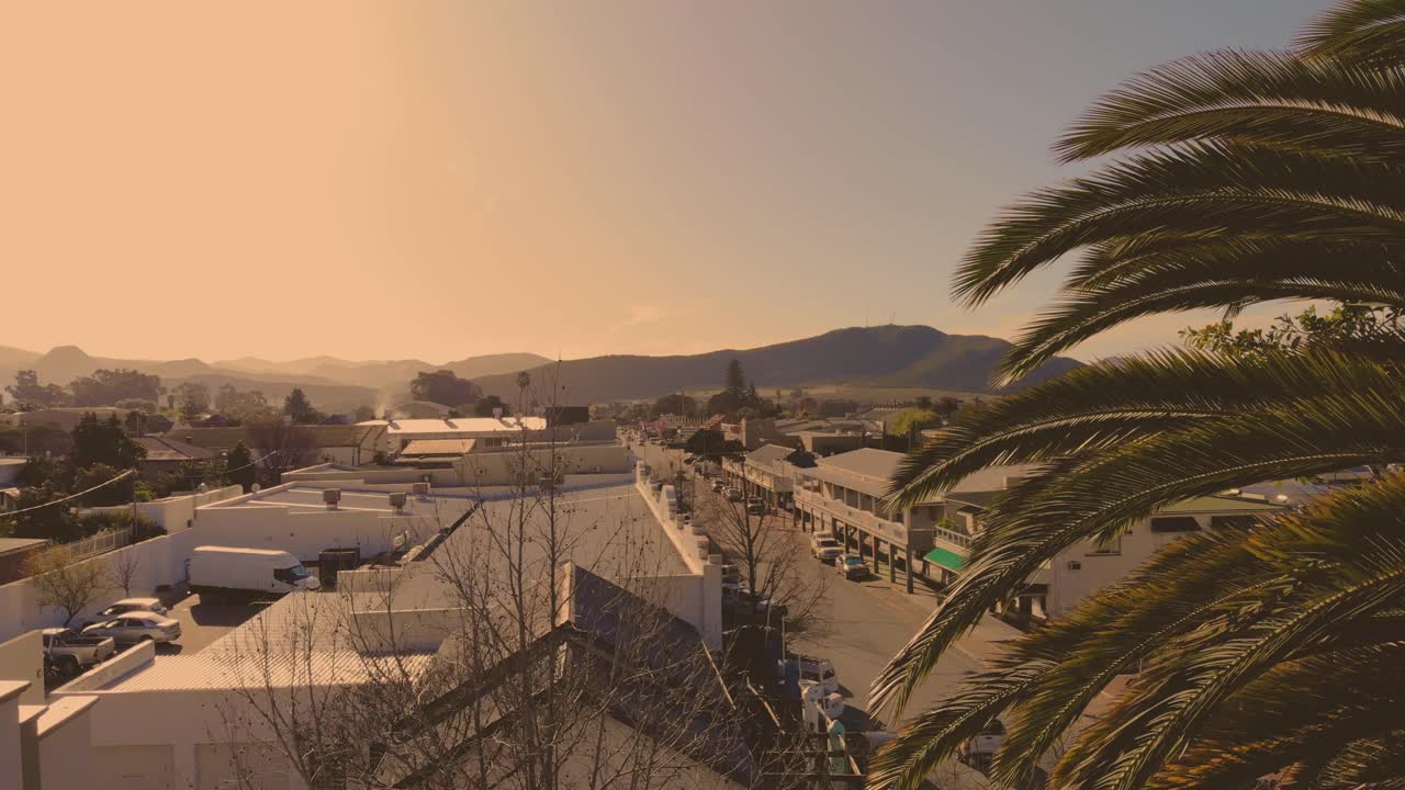 A picturesque drone journey begins in the charming town of Montagu, capturing the idyllic streets and scenery as it gracefully ascends into the open skies