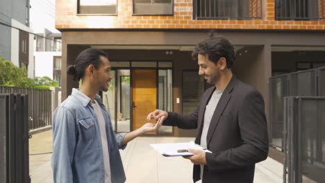 a happy asian man sign an agreement contract signature for real estate to broker or agent for customer for buy or sell a new home or house. people