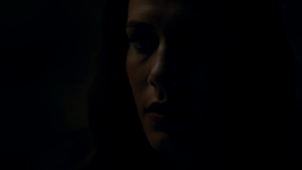 Reacción a la luz tenue, mujer cambiando la mirada, apretando los labios, reflejada en una habitación oscura, zona de luz