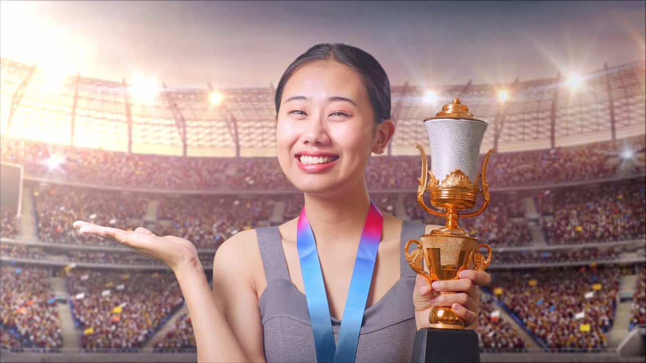 Woman holding a trophy at a stadium