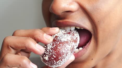 men eating tndian sweet close up