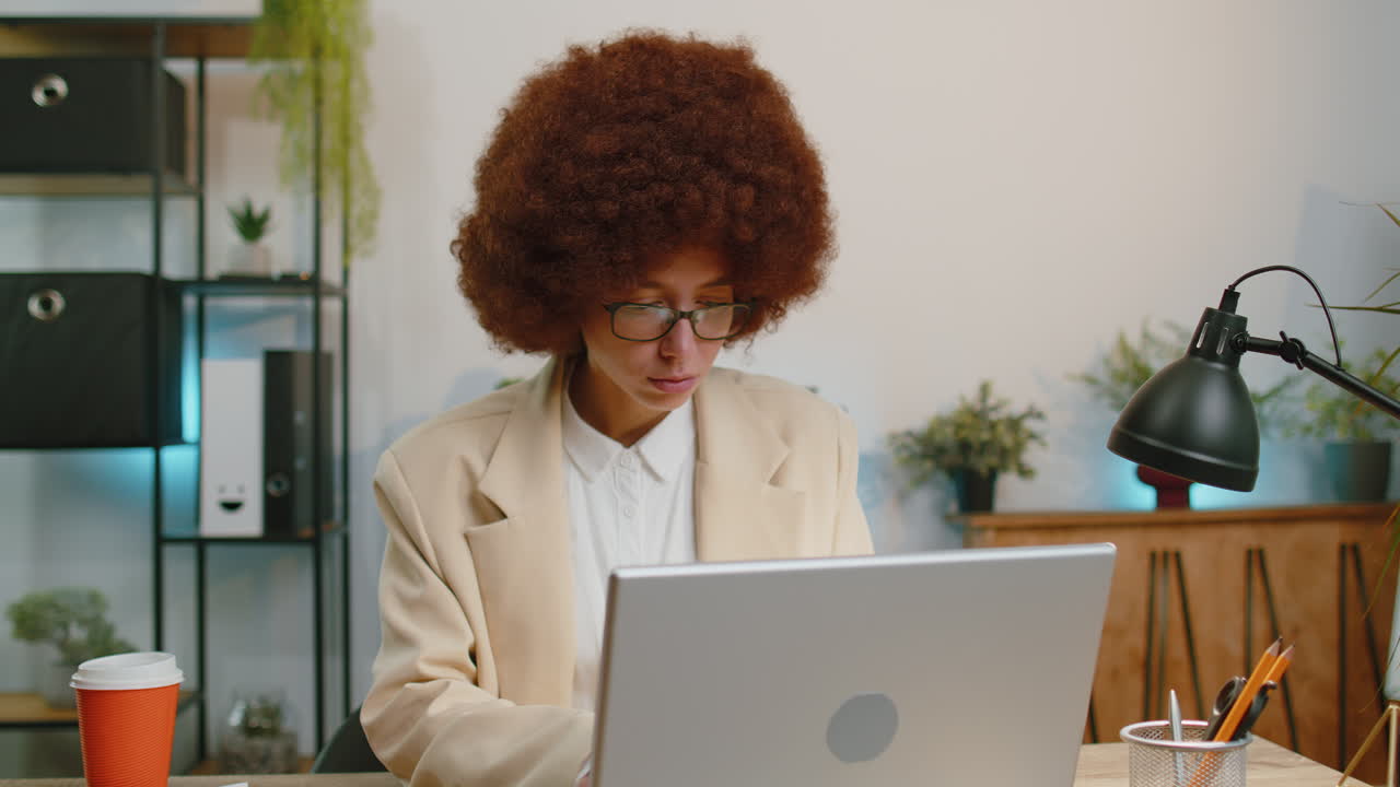 Smiling business woman closing laptop after finishing online work remote job from home office
