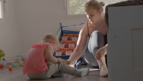 Toddler-girl-learning-colours-with-mum-and-book