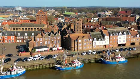 aerial view of kings lynn riverfront, three fishing trawlers and the river great ouse, kings lynn, norfolk, uk