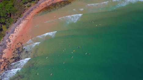 Several-Tourists-Surfing-On-Turquoise-Beach-In-Noosa-Heads-National-Park,-Queensland,-Australia