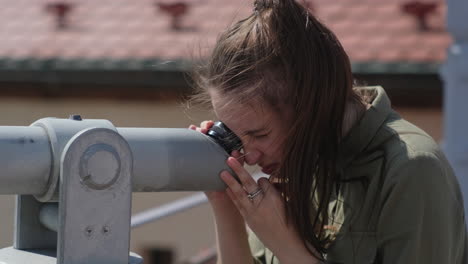 woman looking through a telescope