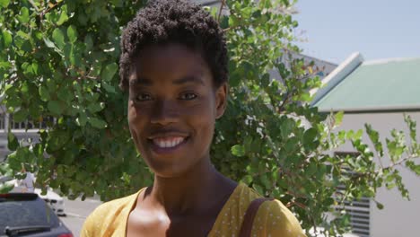 portrait of a young woman smiling in the street