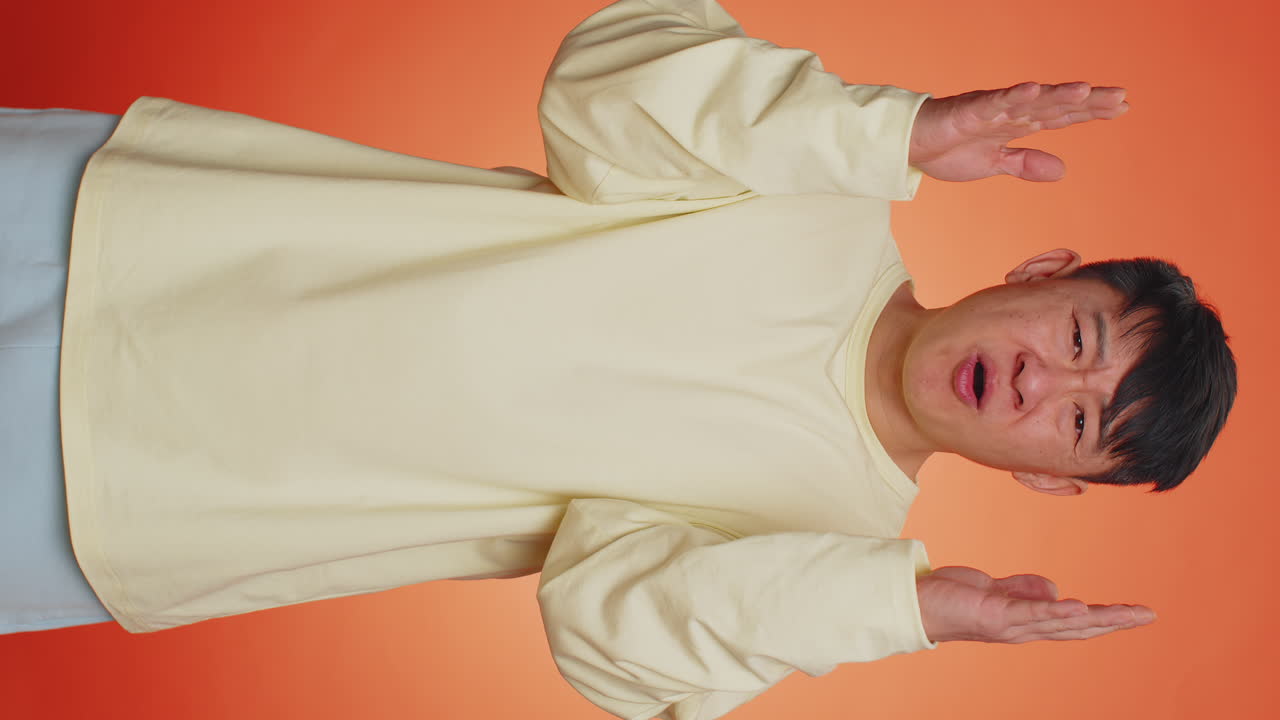 Handsome asian man loses becoming surprised by lottery results bad fortune loss unlucky news