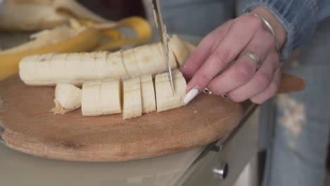 close up scene of a woman cutting a banana