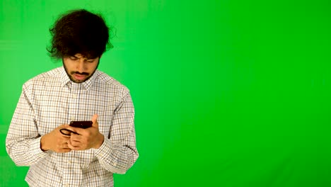 guy-using-mobile---tablet-with-green-screen-and-green-background-indian-guy-with-green-screen