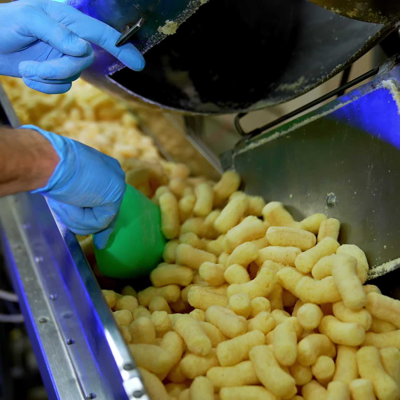 Sticks of corn making in the factory. Snacks of corn making for kids