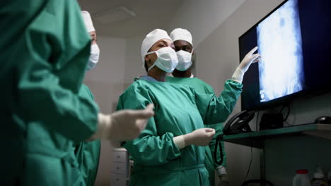 Diverse-male-and-female-surgeons-operating-on-patient-in-operating-theatre-at-hospital,-slow-motion