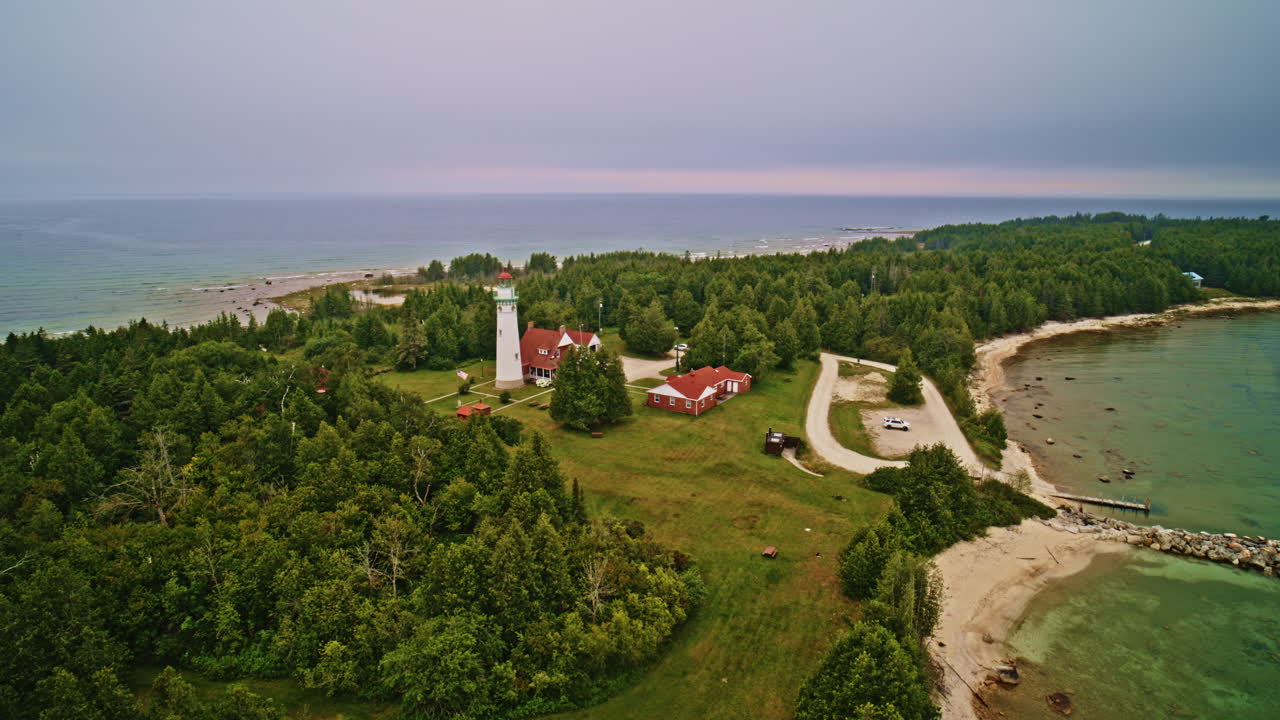 Drone shot panning and dipping around lake Michigan lighthouse