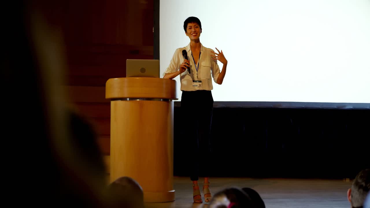 Young Asian businesswoman speaking in business seminar in auditorium 4k