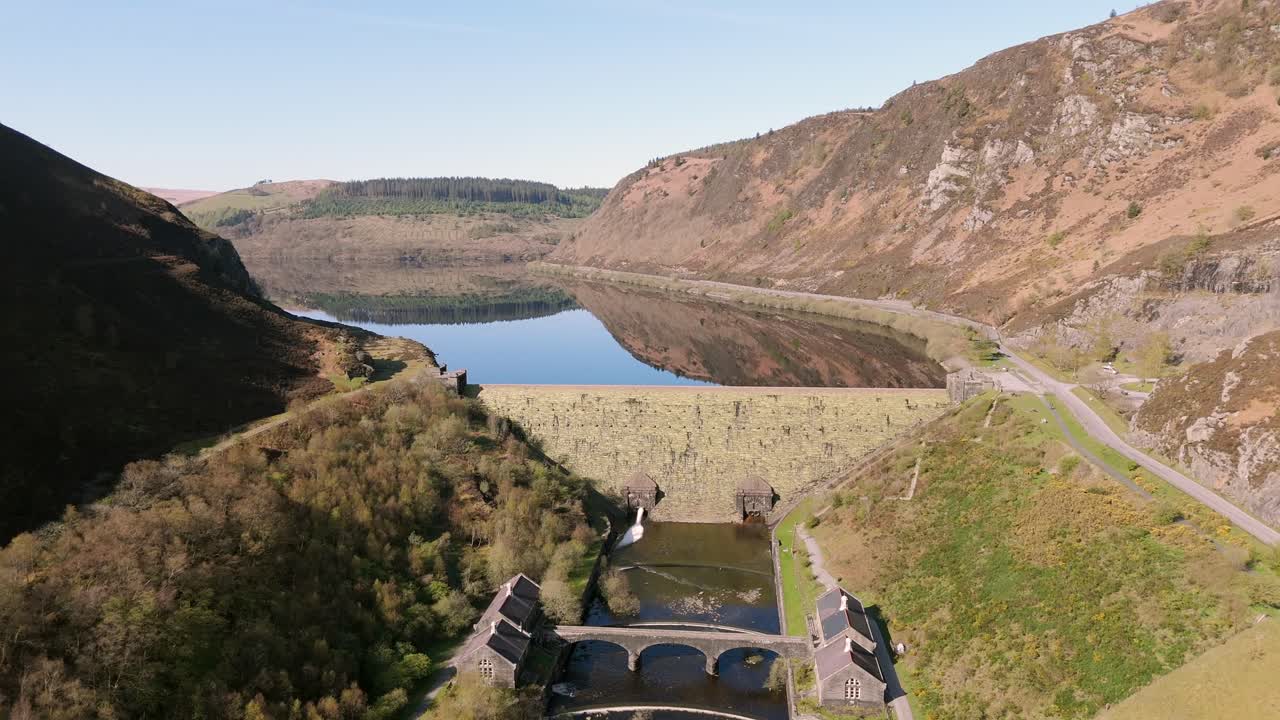 An aerial view of Caban Coch dam and reservoir on a sunny spring day in the Elan valley, Powys, Wales