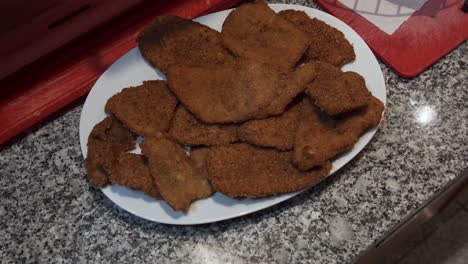 Tray-with-Turkey-Breaded-Steak-on-kitchen-counter