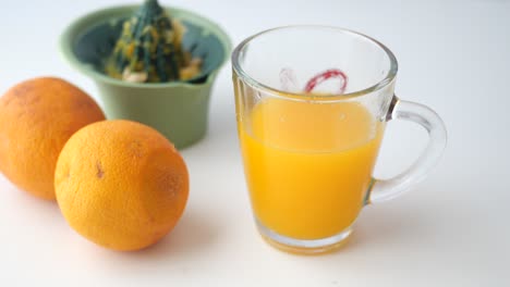 orange juice in a glass mug