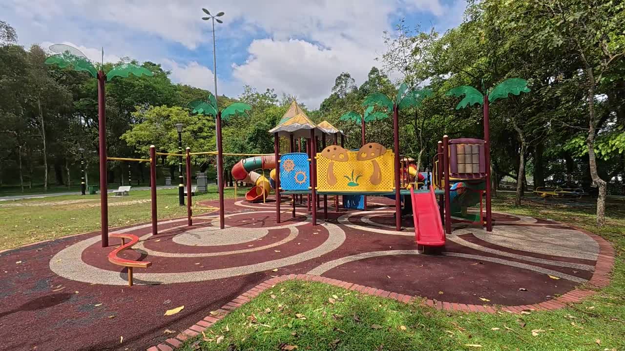 A vibrant public playground for children in a beautiful tropical park. Sunny weather enhances the cheerful outdoor atmosphere