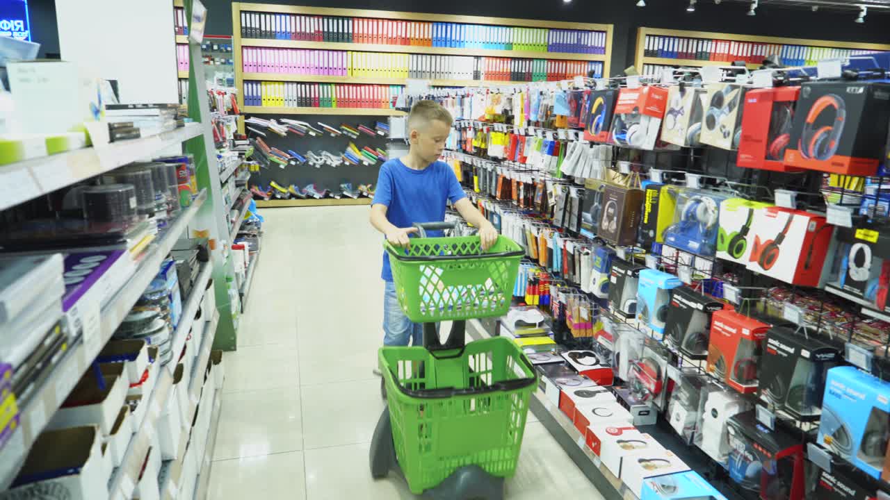VINNITSA, UKRAINE - AUGUST 20, 2018: Back to School. Boy choosing school stationery at the supermarket.