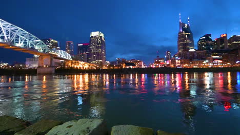 blue hour with city downtown skyline nashville tennessee with reflection lights from the buildings in the cumberland river