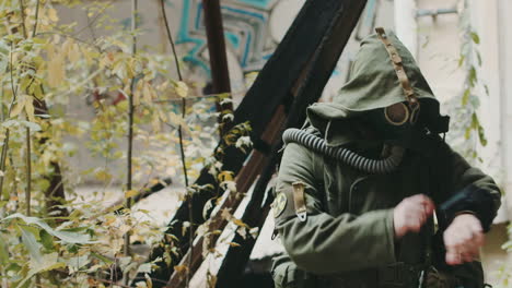 scientist in protective suit looking at the device in his hand he was wearing a gas mask and protect