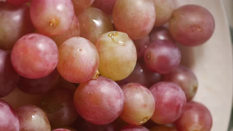 close-up of fresh red and green grapes with water droplets