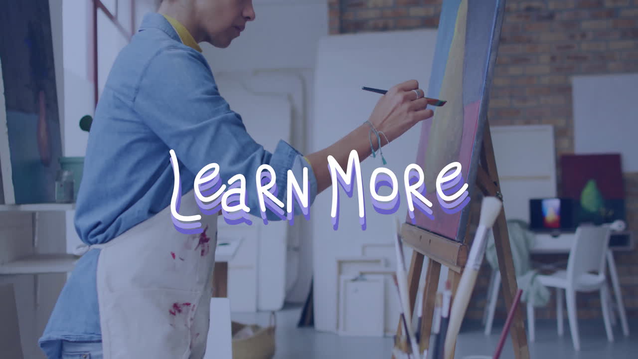 In studio, artist painting on canvas with Learn More text overlay animation