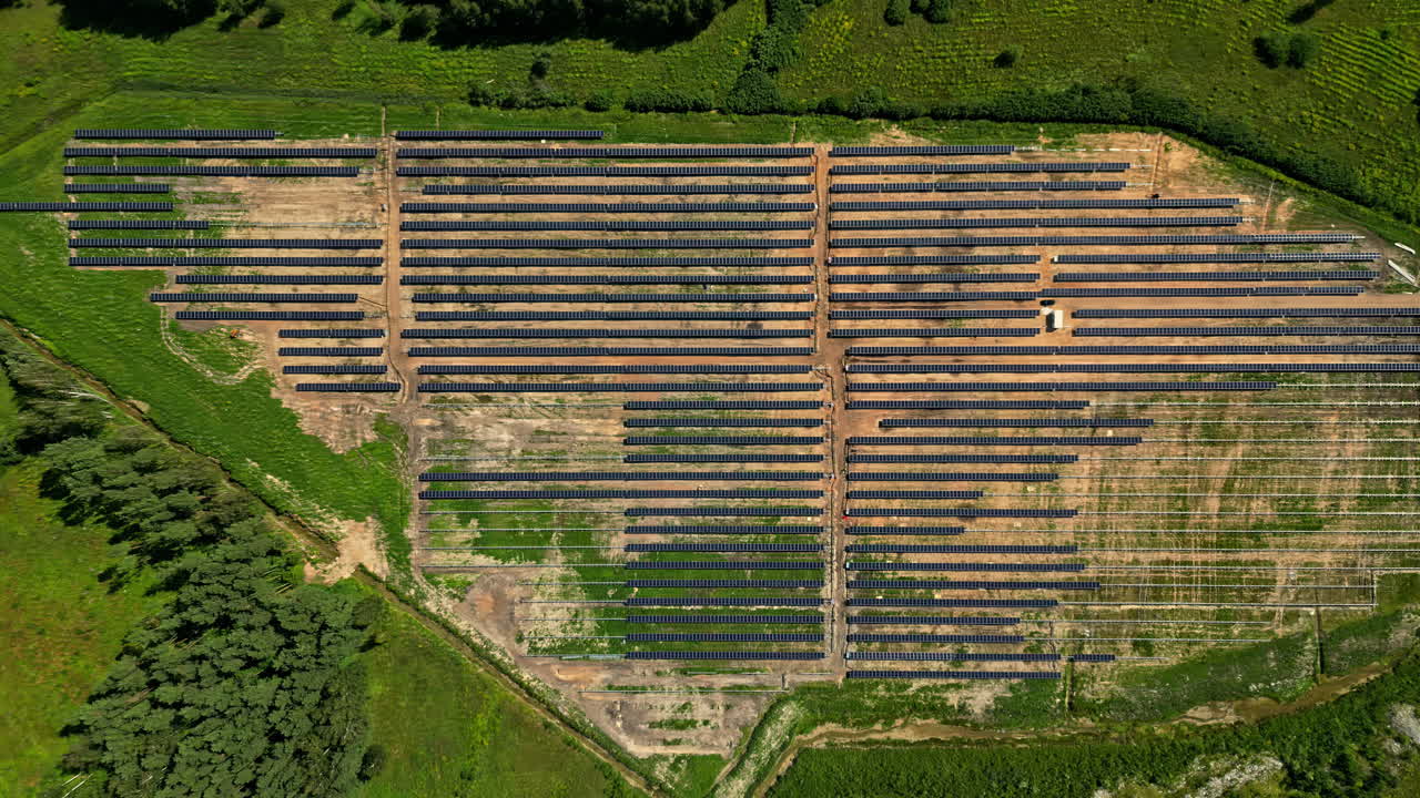 Huge solar panel field under construction, aerial top down view