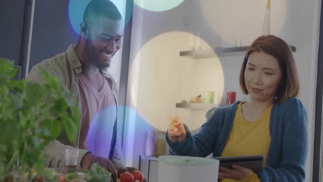 colorful bokeh animation over diverse couple preparing food in kitchen