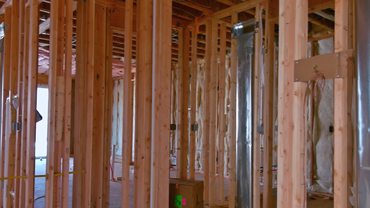 Interior of a new home wooden beams at construction residential house framing