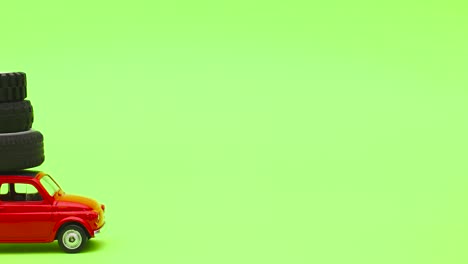 red vintage car drive tires on the roof on green screen - stop motion