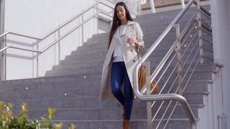 stylish woman walking down a flight of stairs