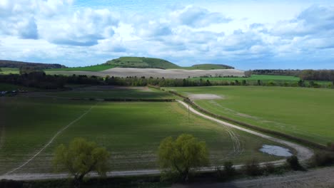 Drone-flying-fast-over-fields-and-farmland-in-Wiltshire-nature,-England