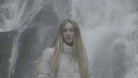 woman by a waterfall