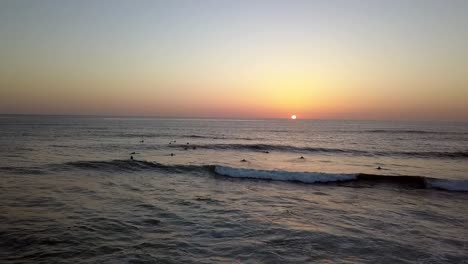 slow motion surfer in water no cloud sky unbelievable aerial view flight pan from right to left drone footage at sunset san diego windansea beach usa 2018