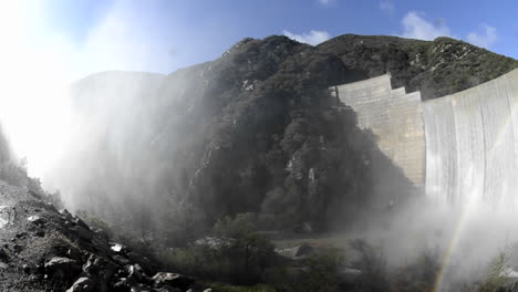 Wide-angle-panning-shot-of-rainbow-below-Matilija-Creek-spilling-over-the-obsolete-Matilija-Dam