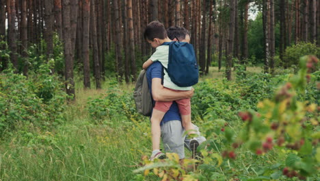 man and kid in the forest