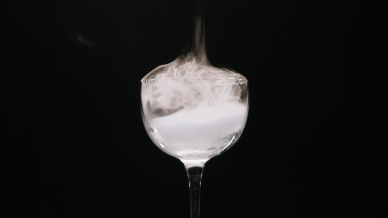 Dramatic White Smoke Swirling in a Clear Glass