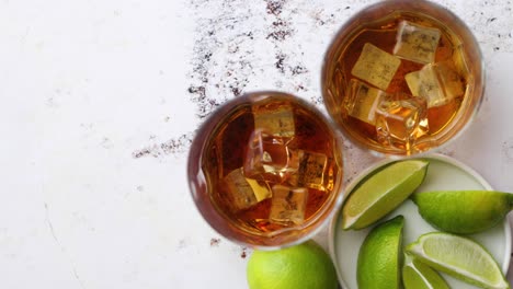 whiskey sour drink with lemon in glass on stone rustical background